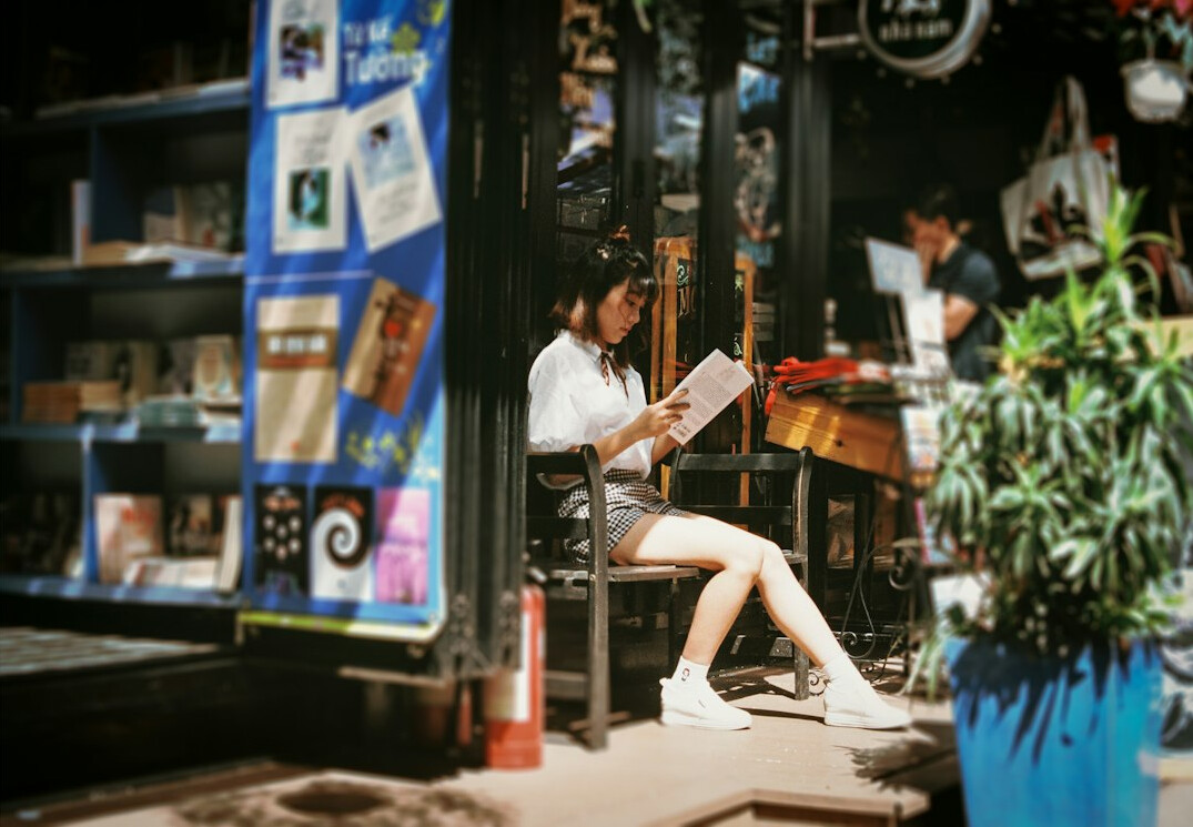 person reading book cafe